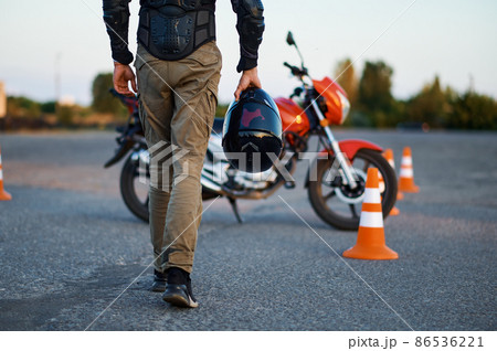 Male person holds helmet, motorcycle school 86536221