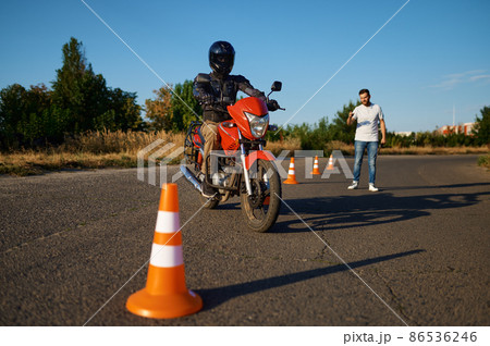 Student and instructor, exam in motorcycle school Student and instructor, exam in motorcycle school 86536246