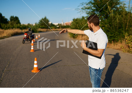 Student rides around the cones, motorcycle school Student rides around the cones, motorcycle school 86536247