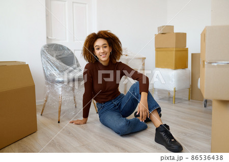 Woman sitting among carton boxes with beginnings Woman sitting among carton boxes with beginnings 86536438