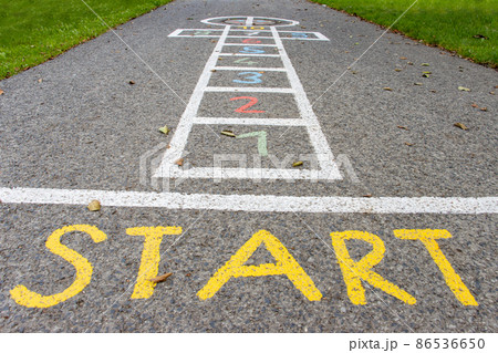 A drawn figure for a children's game - hopscotch on an asphalt road A drawn figure for a children's game - hopscotch on an asphalt road 86536650