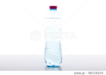 A bottle of sparkling water on the table. Plastic bottle with water on a white background. 86538204