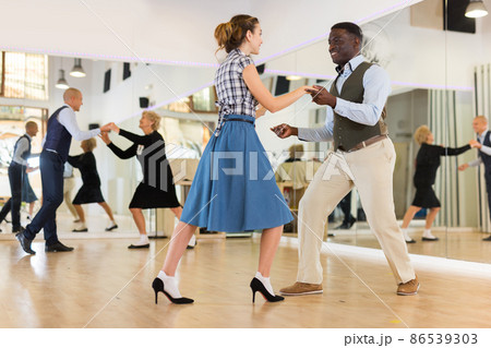 Pair dancing lindy hop during rehearsal Pair dancing lindy hop during rehearsal 86539303