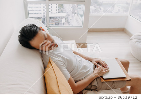 Man works from home with his laptop in the apartment but tired and slept. 86539712