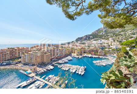 Panoramic image of Port Fontvieille - Monaco, top view from Monaco Ville, azur water, sun reflections on the water, harbour at sunny day, luxury apartments, a lot of yachts and boats, mountain Panoramic image of Port Fontvieille - Monaco, top view from Monaco Ville, azur water, sun reflections on the water, harbour at sunny day, luxury apartments, a lot of yachts and boats, mountain 86540391