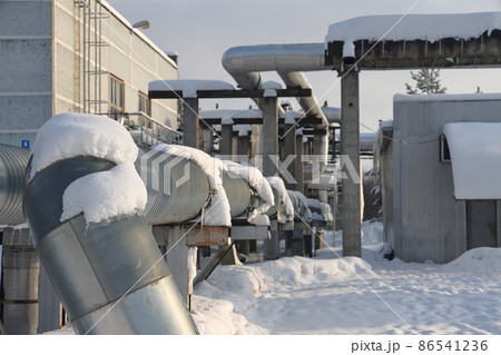 The main provides the city with hot water. Selective focus. The large pipes of the central heating system are covered with snow. Icicles on pipes. fuel crisis. Increasing the cost of heating. 86541236
