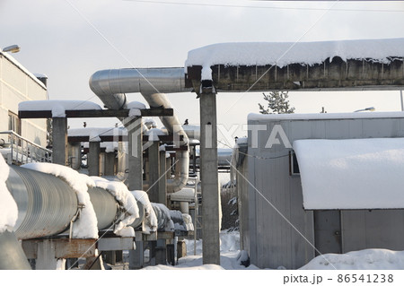 The main provides the city with hot water. Selective focus. The large pipes of the central heating system are covered with snow. Icicles on pipes. fuel crisis. Increasing the cost of heating. 86541238