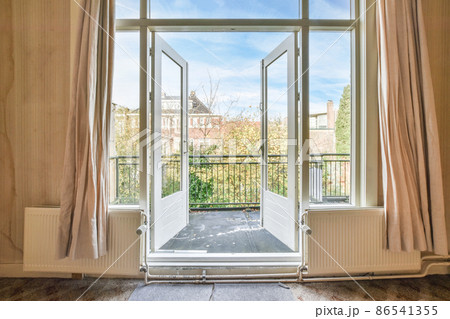 opened doors of the balcony of a classic house opened doors of the balcony of a classic house 86541355