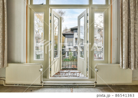 opened doors of the balcony of a classic house opened doors of the balcony of a classic house 86541363