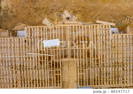 Floor joists in laying the second floor on a new apartment development Floor joists in laying the second floor on a new apartment development 86547717