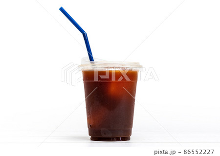 black coffee or ice americano in a cup with blue straw on white background 86552227