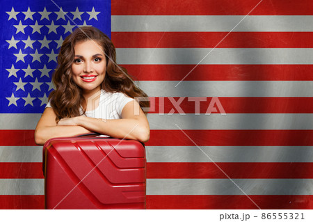 Happy smart woman with backpack against USA flag background Happy smart woman with backpack against USA flag background 86555321