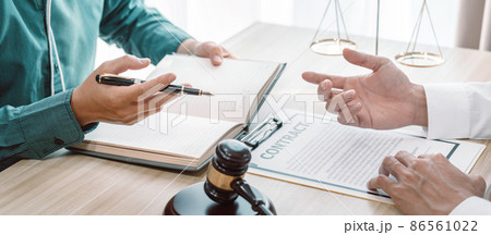 Male lawyer is meeting with businessman client to discuss consultation with litigation contract papers document of estate working in a workplace Male lawyer is meeting with businessman client to discuss consultation with litigation contract papers document of estate working in a workplace 86561022