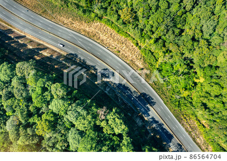 Aerial view of traffic on the road in mountains. Aerial view of traffic on the road in mountains. 86564704