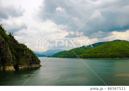 Scenery of Vidraru Dam and lake. Vidraru Dam, Romania. Carpathian Mountains, Fagaras ridge. Scenery of Vidraru Dam and lake. Vidraru Dam, Romania. Carpathian Mountains, Fagaras ridge. 86567521