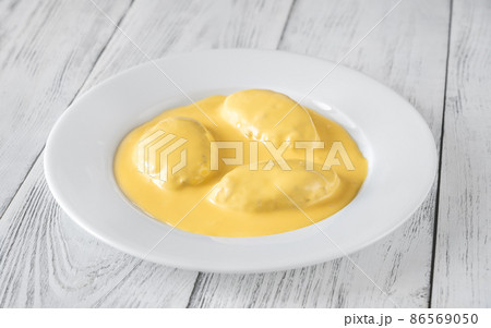 Quenelle with Hollandaise sauce Quenelle with Hollandaise sauce 86569050