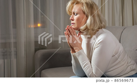 Middle aged woman rests on sofa in living room after work Middle aged woman rests on sofa in living room after work 86569673