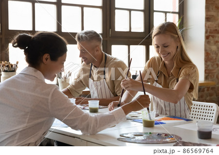 Cheerful diverse art school classmates girls talking on class Cheerful diverse art school classmates girls talking on class 86569764
