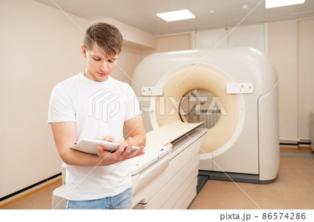 engineer fills after maintenance documents. computer tomograph. engineer fills after maintenance documents. computer tomograph. 86574286