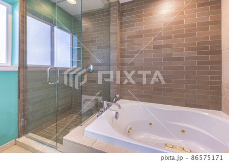 Bathroom interior with brown tiles surround on the stall and tub Bathroom interior with brown tiles surround on the stall and tub 86575171