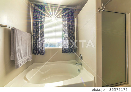 Bathroom interior with sunrays through the window blinds 86575175