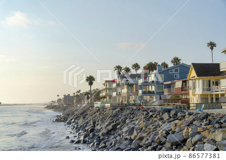 Oceanside beach houses in California with stairs on the natural rock seawall Oceanside beach houses in California with stairs on the natural rock seawall 86577381