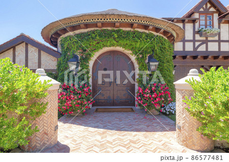 Antique arched double door with wrought iron in a mediterranean style house in La Jolla, California 86577481