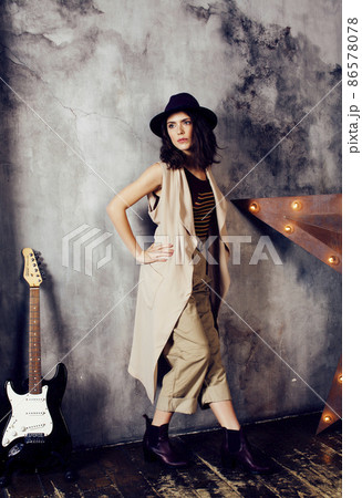 young pretty woman waiting alone in modern loft studio, fashion clothers wearing hat, lifestyle and people home concept 86578078