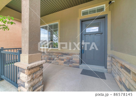 Front porch with security camera above the gray front door with window panel and lockbox Front porch with security camera above the gray front door with window panel and lockbox 86578145
