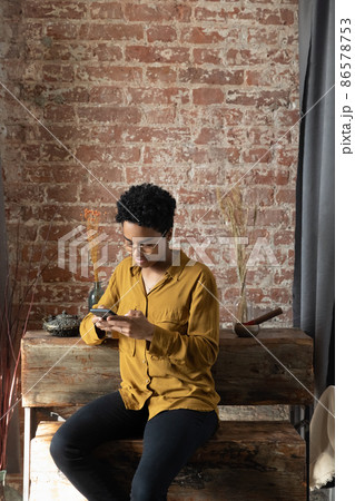 Focused Afro American business woman in glasses typing text message 86578753