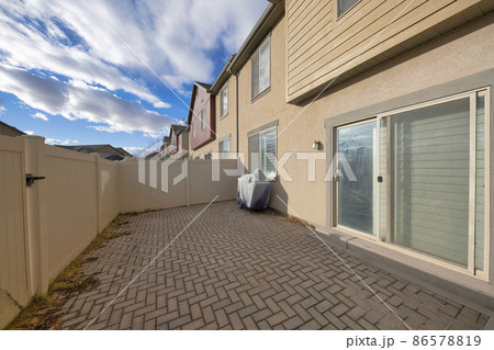 Backyard of a complex houses with sliding door and fence Backyard of a complex houses with sliding door and fence 86578819