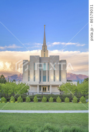 Facade of a fenced LDS church against the mountains and sunset sky at Utah Facade of a fenced LDS church against the mountains and sunset sky at Utah 86579031