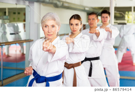 Women and men doing kata during karate training 86579414