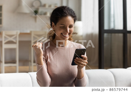 Woman read news on cellphone feels happy got unbelievable offer Woman read news on cellphone feels happy got unbelievable offer 86579744