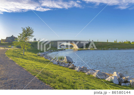 Oquirrh Lake at Daybreak, Utah with rocky shoreline 86580144