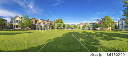 Large green field with trees in the middle of residential are at Daybreak, Utah 86580200