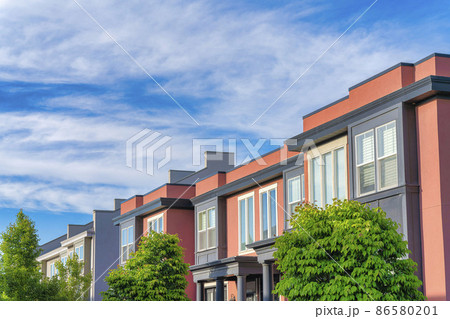 Townhouses building with coral and dark gray siding at Daybreak, Utah Townhouses building with coral and dark gray siding at Daybreak, Utah 86580201