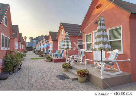 Row of small cabins with coral pallette exterior at Oceanside, California 86580810