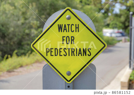Reflective yellow pedestrian signs at the side of the road in Newport Beach, California Reflective yellow pedestrian signs at the side of the road in Newport Beach, California 86581152