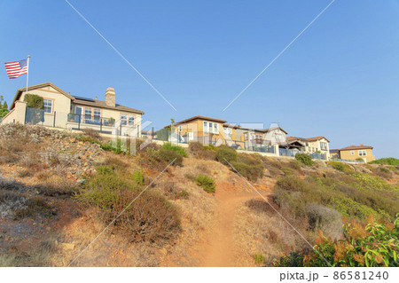 Dirt uphill trail on a rocky slope outside the fenced homes at San Marcos, California Dirt uphill trail on a rocky slope outside the fenced homes at San Marcos, California 86581240