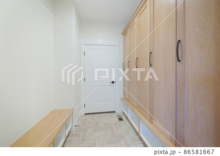 Mudroom interior of a house with white walls and door 86581667