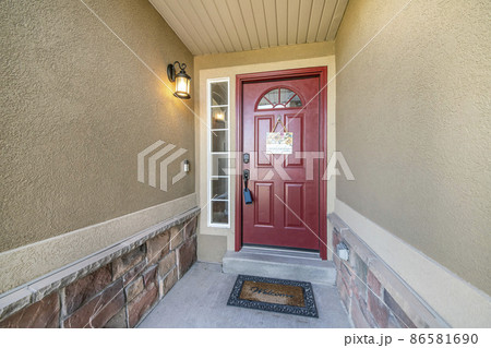 Red front door with lockbox and hanging welcome signboard Red front door with lockbox and hanging welcome signboard 86581690