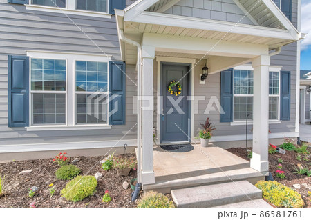 Home exterior with gray wood vinyl siding and white frames Home exterior with gray wood vinyl siding and white frames 86581761