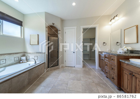 Master bathroom interior with antiqued limestone tiles Master bathroom interior with antiqued limestone tiles 86581762