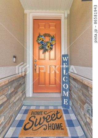 Bronze front door with wreath and stylish doormat with home sweet home statement Bronze front door with wreath and stylish doormat with home sweet home statement 86581943