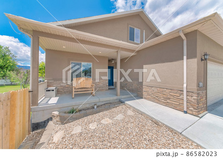 Exterior of a light brown two-storey house with garage 86582023