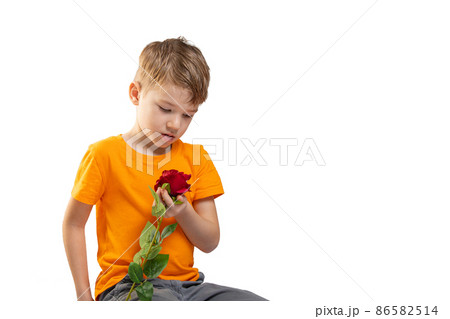 Beautiful little boy toddler holding flower on white. Mother's day concept. Beautiful little boy toddler holding flower on white. Mother's day concept. 86582514