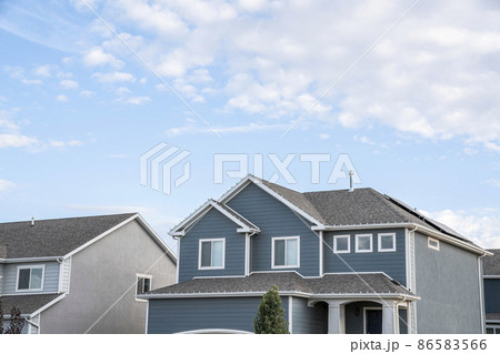 Low angle view of two-storey houses with gray and blue sidings 86583566
