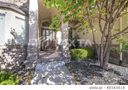 Front entrance of a house with chandelier and huge wooden door with reflective glass panels Front entrance of a house with chandelier and huge wooden door with reflective glass panels 86583618