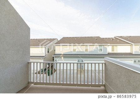 Roof deck of a house with railing and a view of neighborhood 86583975